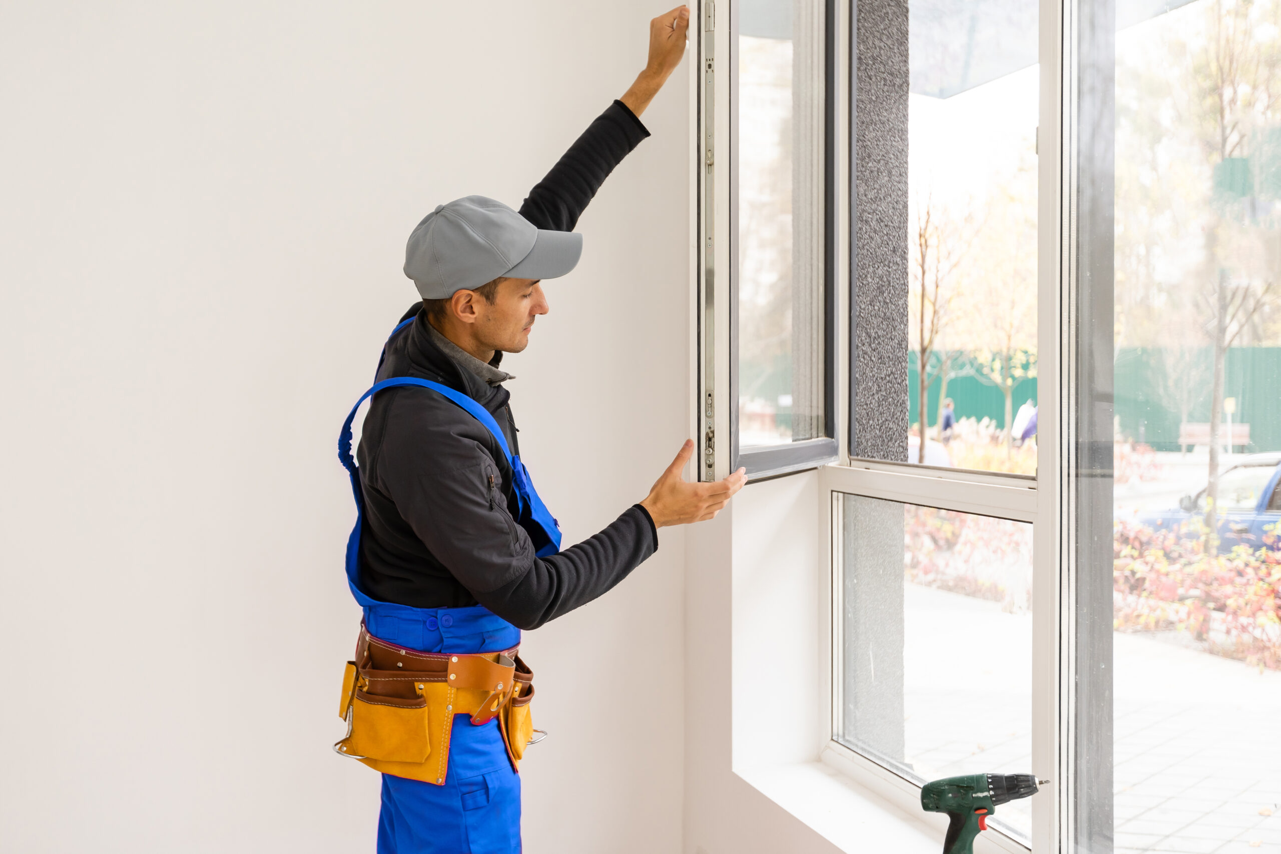 Construction Worker Installing New Windows In House.